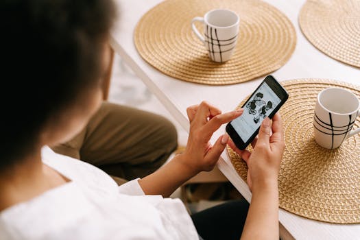 Woman browsing online store for baby stroller using smartphone at home.